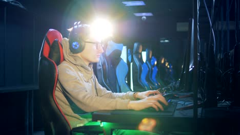 Young-man-in-glasses-and-headphones-is-playing-a-computer-game