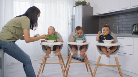 Asiatische-Baby-Triplets-Essen-Püree-für-das-Mittagessen-zu-Hause