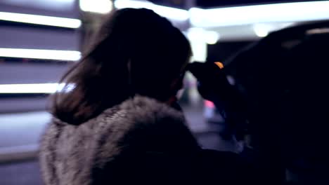 Young-girl-frustrated-waiting-for-help-beside-broken-car-with-open-hood-talking-on-the-phone