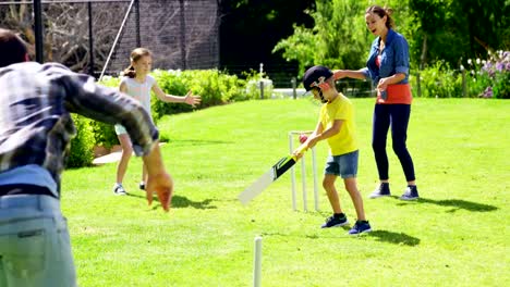 Family-playing-cricket-in-park