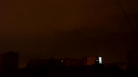 view-from-the-window-to-the-stormy-sky.-night-outside,-outside-the-window-dressed-with-rains-and-lightning-flashed.-seen-from-the-window-high-houses-FullHD