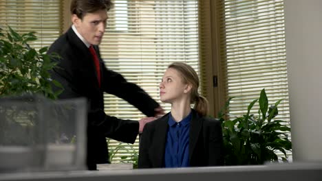 young-guy-in-a-suit-flirts-with-his-employee,-enthusiastically-tells-her-the-story,-gestures-with-his-hands.-Work-in-the-office-concept.-Presentation-60-fps