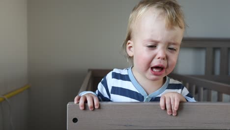 Crying-baby-boy-in-crib-at-home