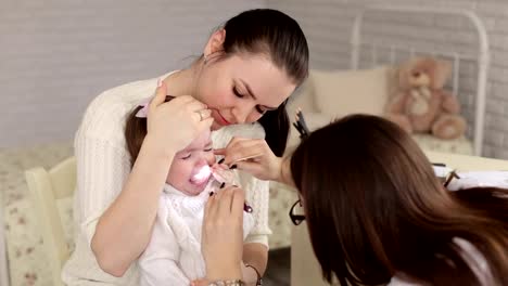 A-child-with-her-mother-at-a-doctor's-appointment.