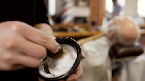 Hairstylist-mixes-shaving-cream-with-brush