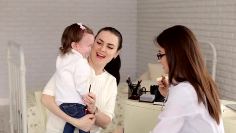 Mom-and-daughter-at-the-reception-at-pediatrician.