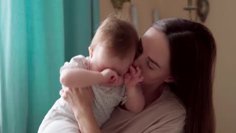 Caring-mother-calms-her-little-crying-child