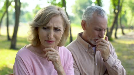 Elderly-couple-crying,-frustrated-with-illness-of-close-relative,-despair