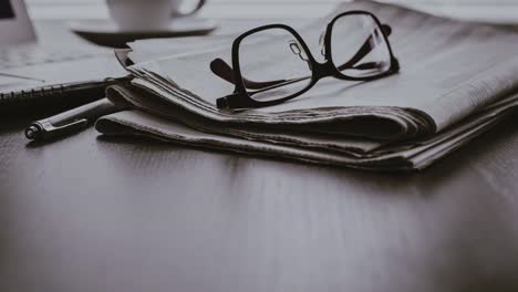 Newspaper-with-computer-on-table