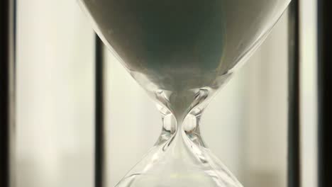 Time-Lapse-of-hourglass-clock-sand-dropping-close-up-shot---Time-speed-moving-fast-with-blinking-daylight