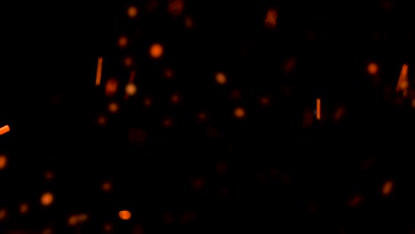 high-speed-shot-of-fire-flames-and-glowing-ash-particles-on-black-background