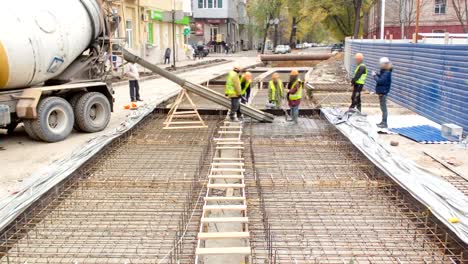 Concrete-works-for-road-maintenance-construction-with-many-workers-and-mixer-timelapse