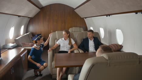 Pretty-stewardess-offers-help-and-service-for-luxury-private-jet-clients