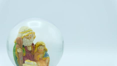 Christmas-nativity-scene-inside-glass-ball-on-white-background.