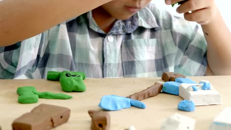 Child's-hands-playing-colorful-clay-on-table.-Development-of-fine-motor-skills-of-fingers-and-creativity,-education