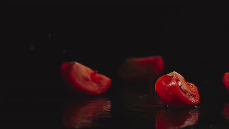 SLOW-MOTION:-Tomato-falls-on-a-table-and-pieces-scatters-in-different-directions