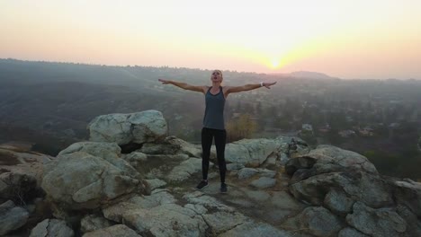 fitness-model-deep-breaths-wellness-aerial-at-sunset