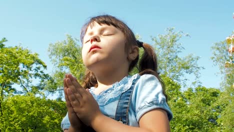 The-child-prays-in-nature.