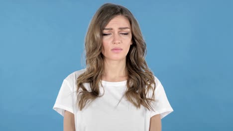 Sad-Upset-Young-Girl-Isolated-on-Blue-Background