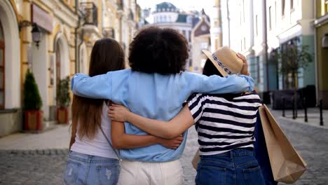 Multiracial-girls-embracing-while-shopping