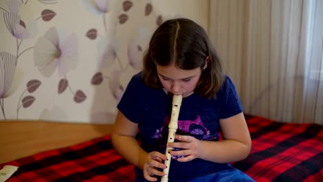 Girl-Practicing-Flute-at-Home