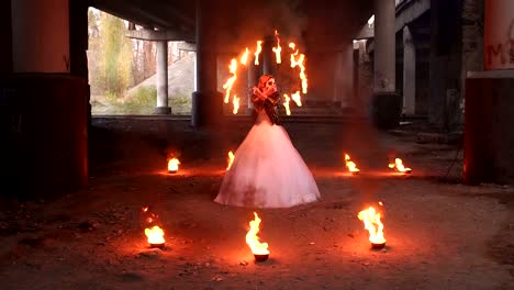 Creepy-bride-with-makeup-on-her-face-holding-burning-torches.-Halloween.