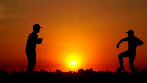 Silhouette-baseball,-two-men-were-practicing-throwing-a-baseball-and-getting-together