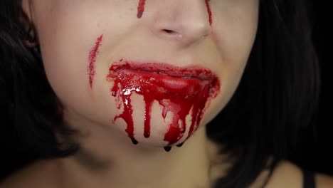 Bloody-mouth-and-teeth-of-girl.-Vampire-Halloween-makeup-with-dripping-blood