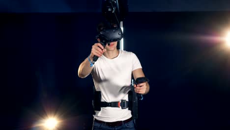 Young-man-playing-games-in-VR-equipment.-Robotic-VR-cybernetic-gaming-system.