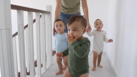 Asian-Toddler-Walking-at-Home-and-Siblings-Following