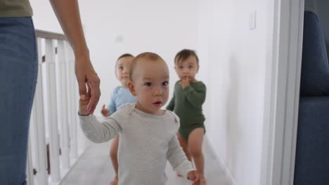 Asian-Boy-Triplets-Learning-to-Walk-at-Home-with-Mom