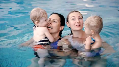 Schwimmbad.-Mütter-bringen-kleinen-Kindern-das-Schwimmen-bei.