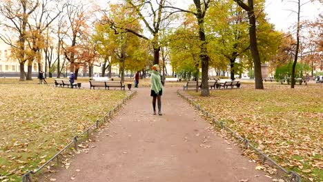 Young-woman-come-towards,-look-around,-search-and-take-out-mobile-phone