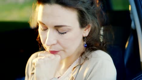 Portrait-of-Caucasian-woman-crying-in-car.-Tears-rolling-down-her-cheeks,-close-up.-Concept---problems-of-relationships,-women's-problems