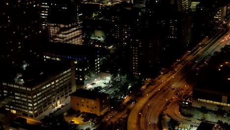 AERIAL:-Brooklyn-Bridge-boulevard-and-lit-up-with-lights-Brooklyn-city-at-night