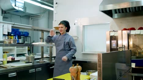 Funny-young-male-cook-dancing-in-the-professional-kitchen