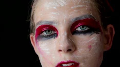 Portrait-of-mysterious-girl-with-creative-make-up-and-elegant-hairstyle