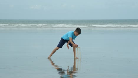 A-young-boy-playing-cricket-as-wicket-keeper-catches-the-ball-and-hits-the-stumps.