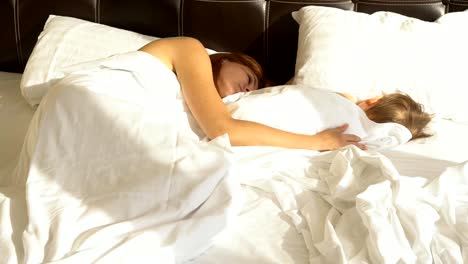 mom-and-son-sleep-in-the-morning-in-bed-at