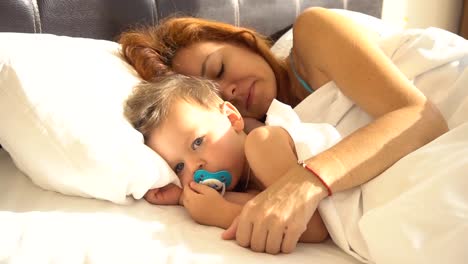 mom-with-son-baby-woke-up-in-the-morning-on-the-bed