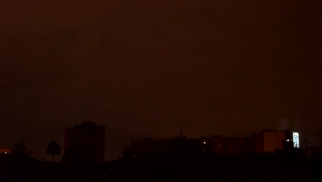 view-from-the-window-to-the-stormy-sky.-night-outside,-outside-the-window-dressed-with-rains-and-lightning-flashed.-seen-from-the-window-high-houses-FullHD