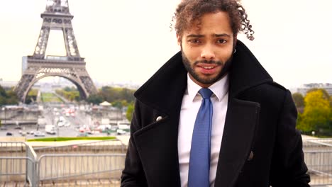 male-model-smiling-near-Eiffel-Tower-in-slow-motion