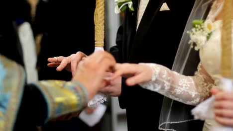 Pastor-of-Orthodox-Church-holding-wedding-ceremony-for-religious-newlyweds