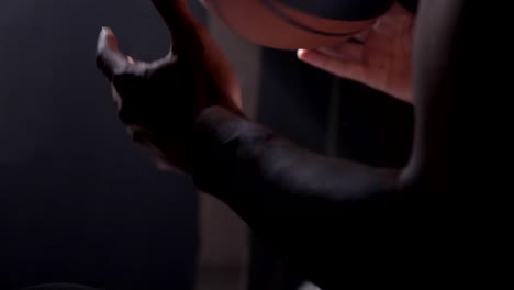 Close-footage-of-black-man's-hand-with-tattoos-playing-with-ball