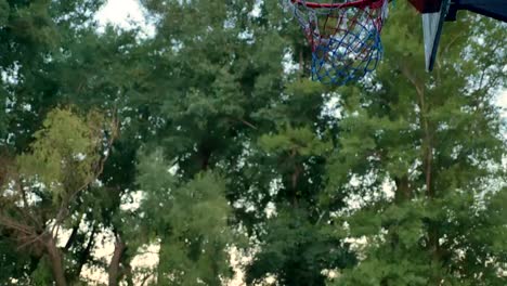 Hermosa-mujer-joven-jugando-baloncesto-y-falla,-la-bola-falta-aro,-practicando-en-el-parque-durante-las-mañanas