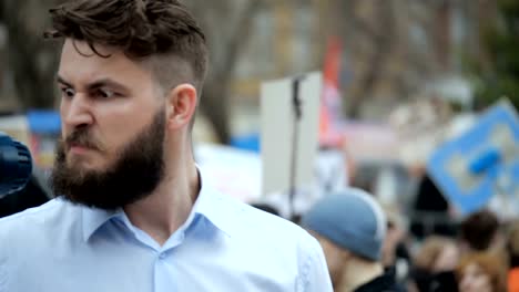 Young-adult-man-shouts-in-megaphone.-Caucasian-people-shout-violently-and-angry.