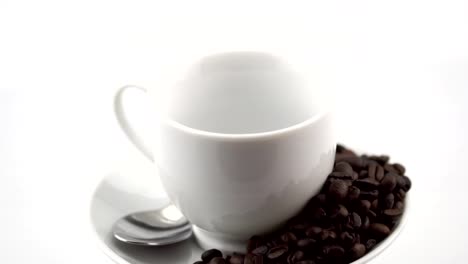 rotating-of-white-coffee-cup-with-coffee-pouring-into-cup-in-slow-motion