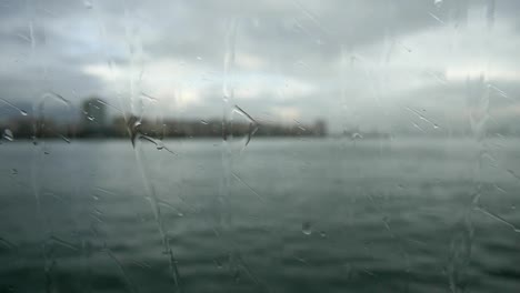 Looking-to-the-Sea-and-Gulf-Through-The-Window-With-Rain-Drops-On-Transparent-Glass-Of-The-Ferry-Boat.