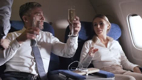 Businesspeople-Drinking-Champagne-on-Plane