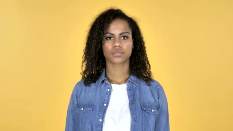 African-Girl-Shaking-Head-to-Reject-Isolated-on-Yellow-Background